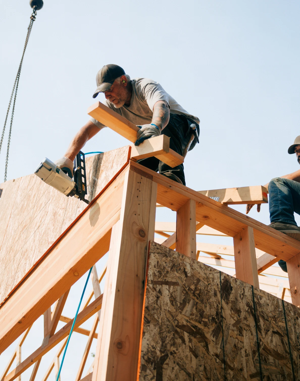 Workers assembling roof trusses