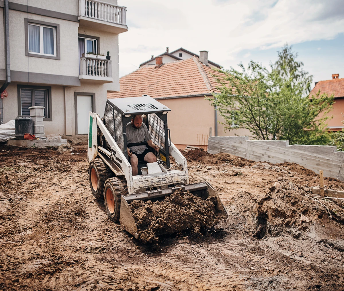 Compact loader on muddy ground