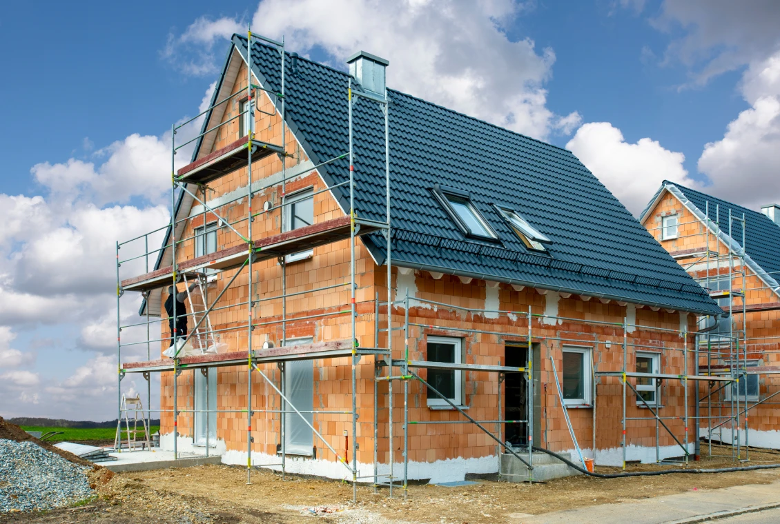 Building site with unfinished brick house